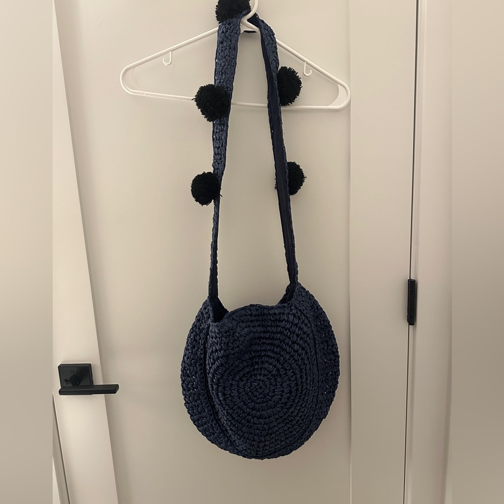 Blue Woven Bobo Bag with Black Pom Poms